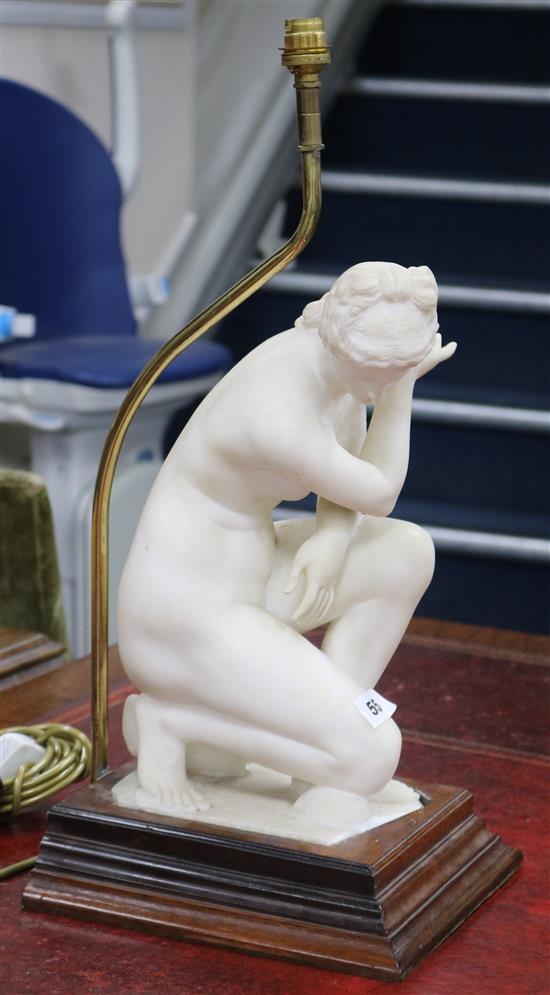A carved alabaster model of Venus crouching, fitted as a table lamp (restored)